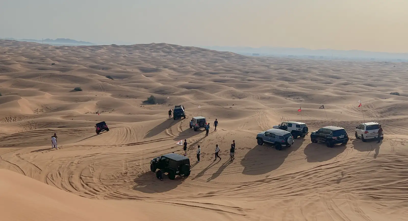 4x4 vehicles and people on the sand dunes of the Alxa desert